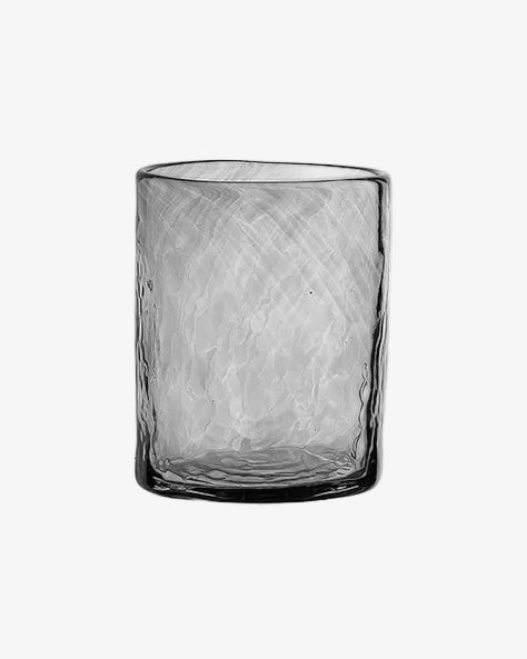 Textured glass tumbler on a white background